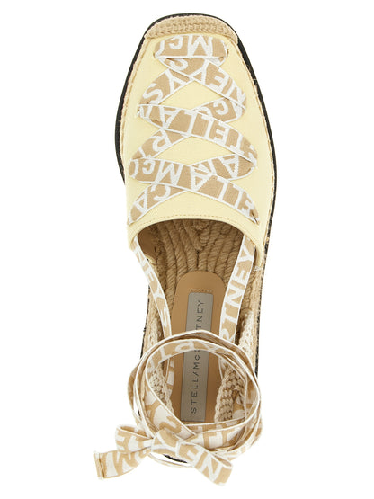 Wedge Sandals by Stella McCartney for women in raffia viscose canvas & faux leather bicolour & yellow features an exquisite silhouette, showcasing the exquisite Women's Raffia Viscose Canvas & Faux Leather Wedge Sandals with a wedge and .