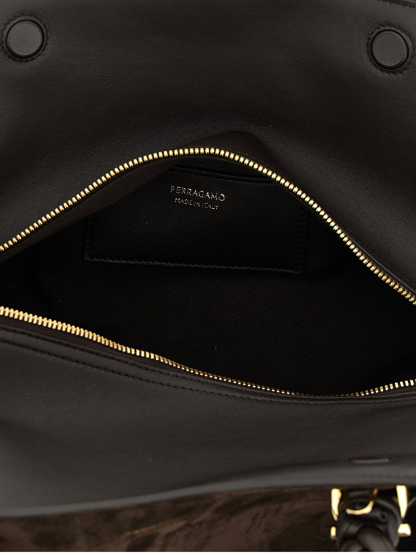 This 2-in-1 Shoulder & Crossbody Handbag by Ferragamo for women in suede leather and brown presents a sculptural silhouette featuring a secure zipper, ample , and versatile crossbody-strap, shoulder-strap, adjustable-strap & handle for a sculptural finish.