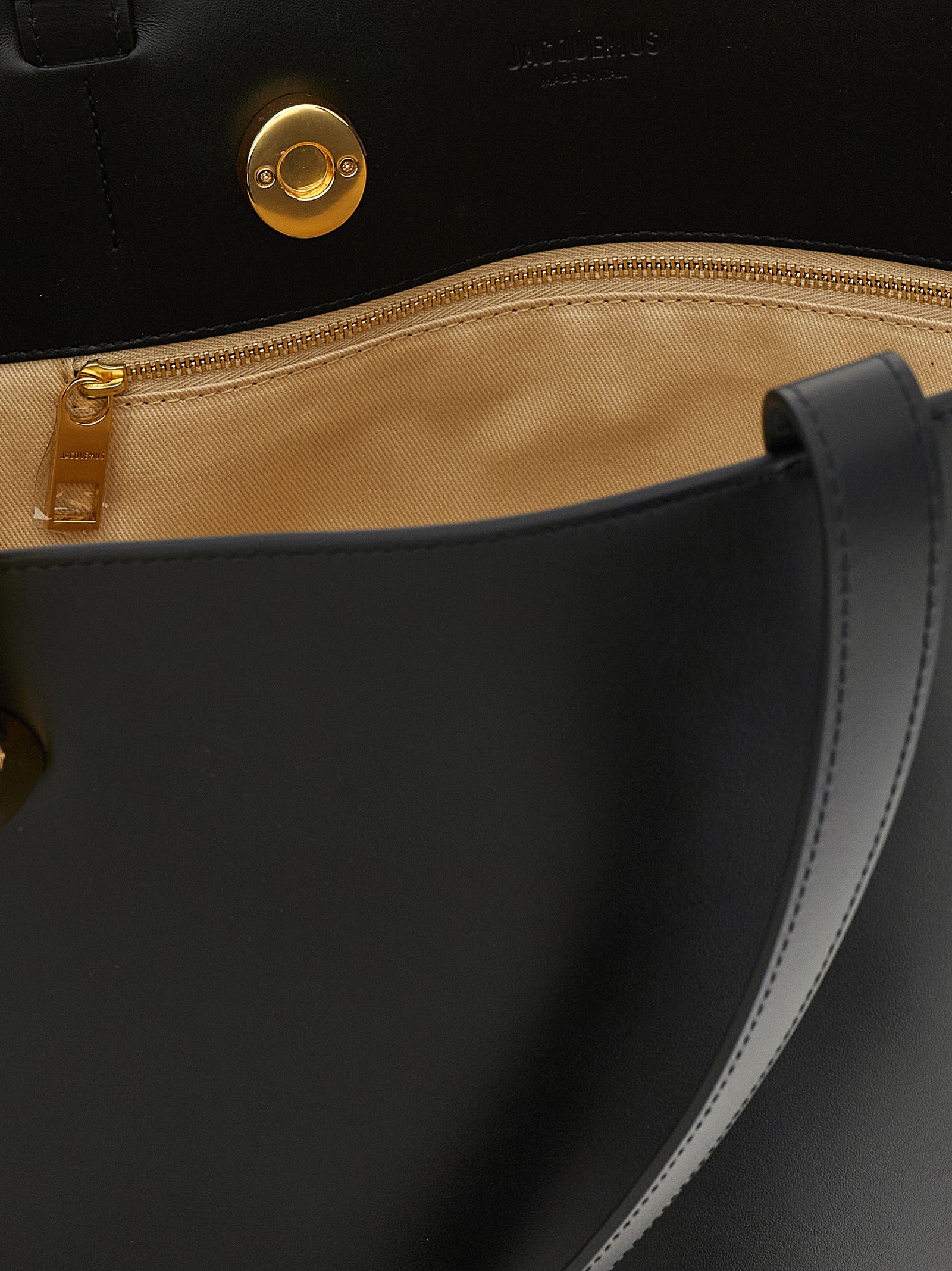 Shoulder Bucket Bag by Jacquemus for women in leather & metal black, gold & patterned features a statuesque silhouette, showcasing a secure clip and statuesque with versatile shoulder-strap & handle for a statuesque finish.