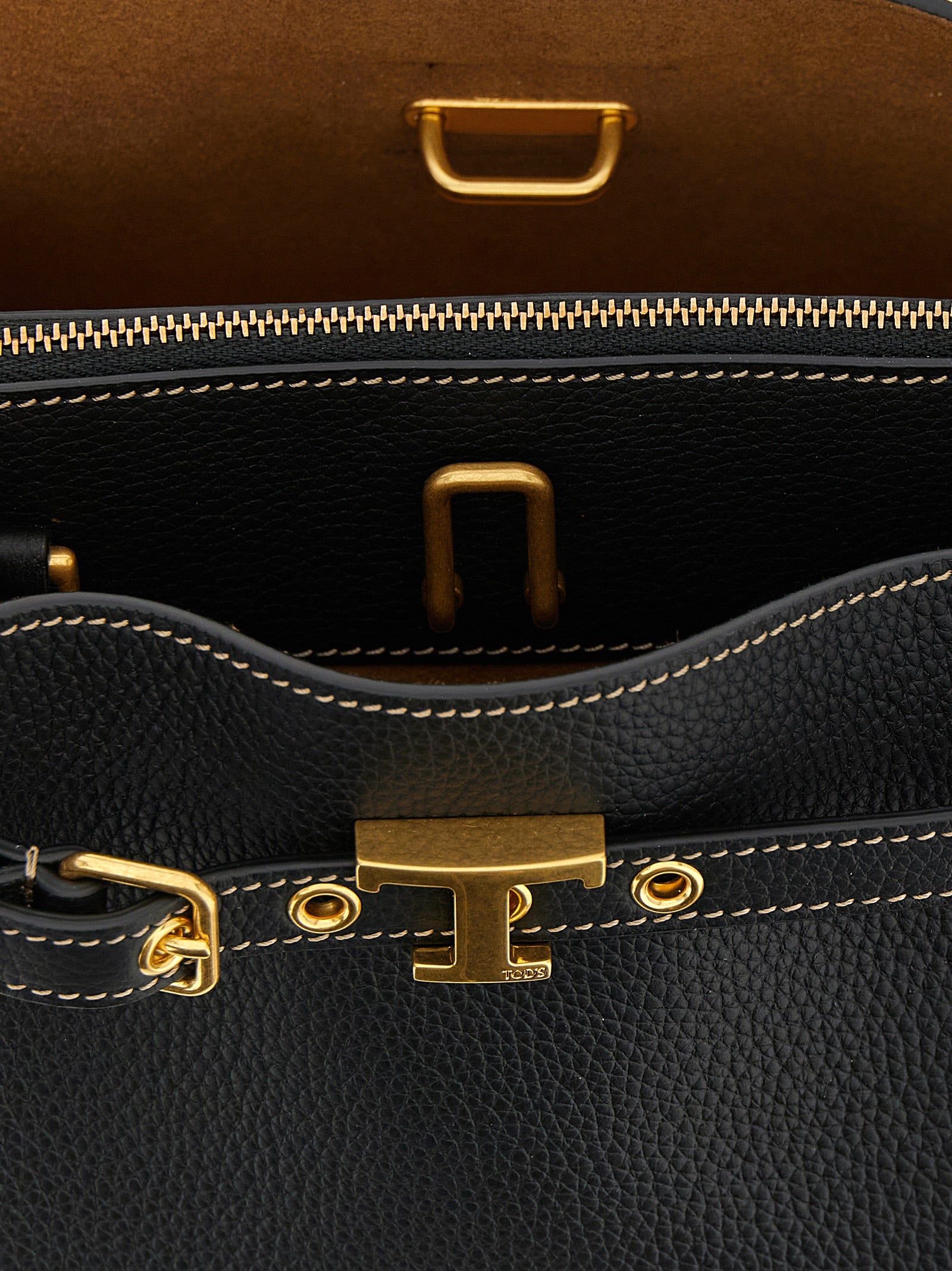 Mini Handbag by Tod's for women in calfskin leather black & signature features a contemporary silhouette, showcasing a secure zipper & buckle, ample built-in-compartments, and contemporary shoulder-strap, adjustable-strap & belt-strap for a sophisticated look.