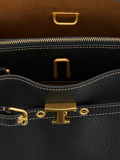 Mini Handbag by Tod's for women in calfskin leather black & signature features a contemporary silhouette, showcasing a secure zipper & buckle, ample built-in-compartments, and contemporary shoulder-strap, adjustable-strap & belt-strap for a sophisticated look.