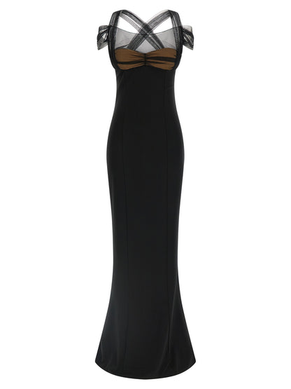 Dress by Nensi Dojaka for women in stretch viscose black & transparent features a dramatic silhouette, showcasing an elegant split neckline and sleeveless that flows into a dramatic maxi long.