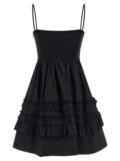 Dress by Ganni for women in stretch organic cotton black features a dramatic silhouette, showcasing an elegant square neckline and that flows into a dramatic short mini.