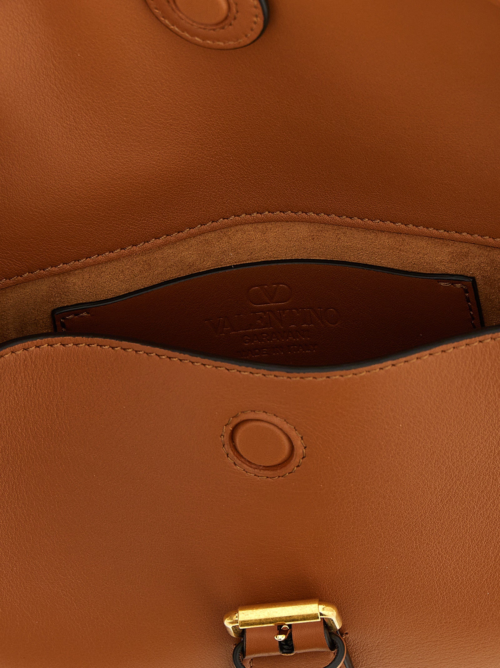 Small Shoulder Flap Bag by Valentino Garavani for women in calfskin leather brown & signature showcases a enviable silhouette, artfully detailed with a secure flap & magnetic, organized , and versatile shoulder-strap & adjustable-strap for a enviable look.
