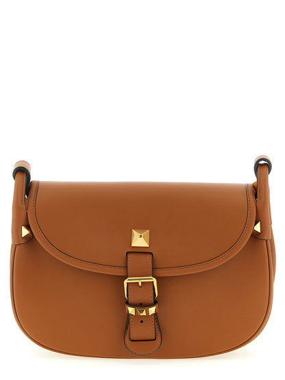 Medium Shoulder Flap Bag by Valentino Garavani for women in calfskin leather brown & signature features a distinguished silhouette, showcasing a secure flap & magnetic and distinguished with versatile shoulder-strap & adjustable-strap for a distinguished finish.