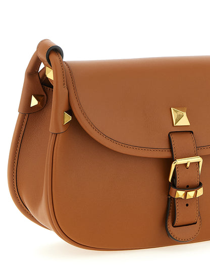 Medium Shoulder Flap Bag by Valentino Garavani for women in calfskin leather brown & signature features a effortless sophistication silhouette, secured by a flap & magnetic with ample and versatile shoulder-strap & adjustable-strap for a effortless sophistication finish.