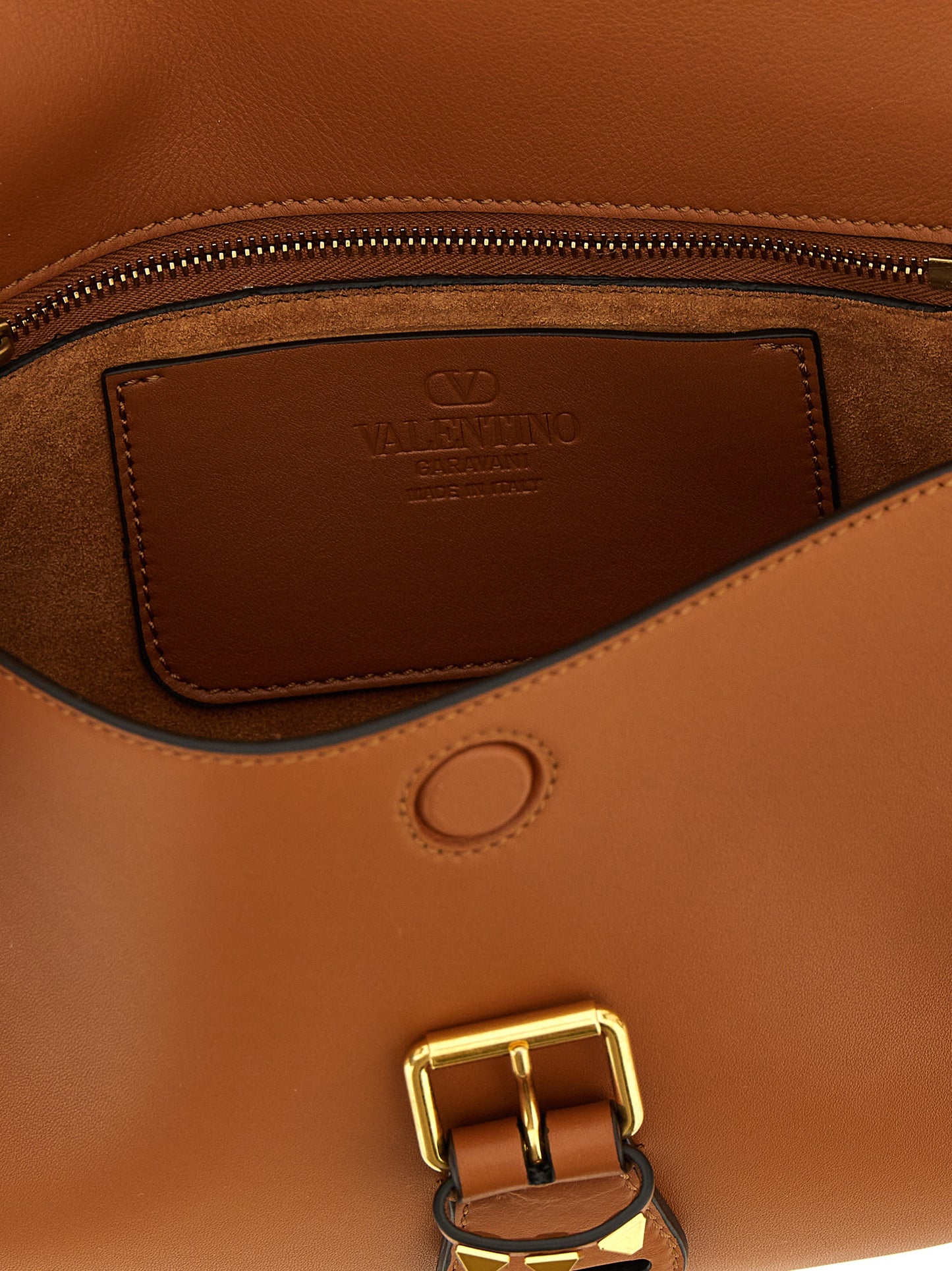 Medium Shoulder Flap Bag by Valentino Garavani for women in calfskin leather brown & signature presents a versatile silhouette, showcasing a secure flap & magnetic and versatile with versatile shoulder-strap & adjustable-strap for a sophisticated look.