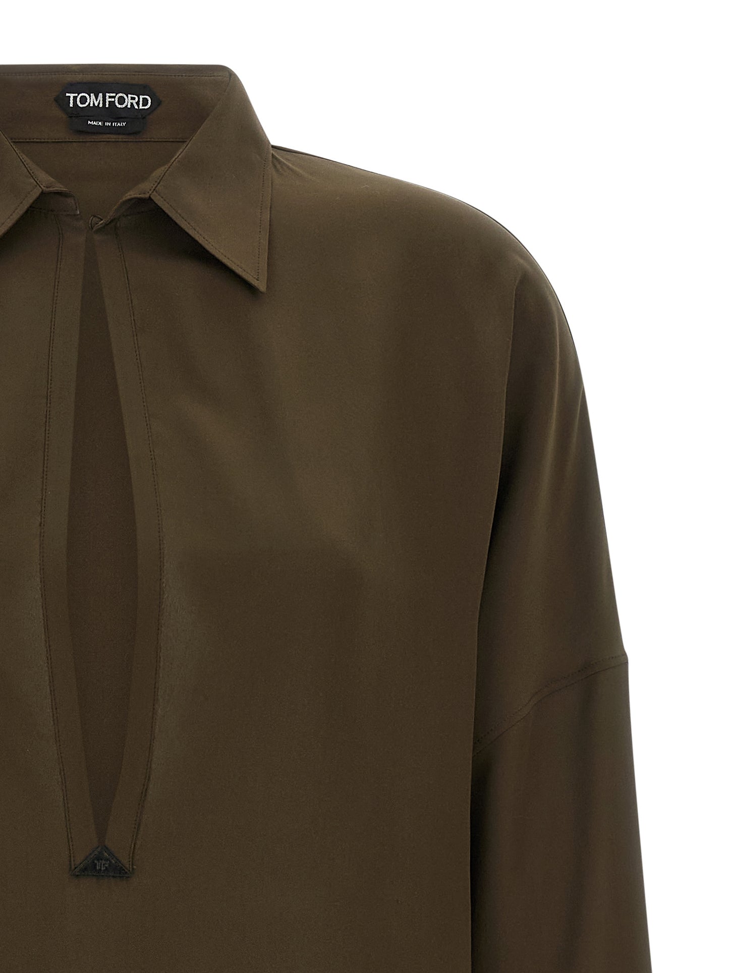 Dress by Tom Ford for women in silk & leather bicolour & green features an sultry silhouette defined by a shirt-collar neckline and , falling to an sultry midi for a sultry look.