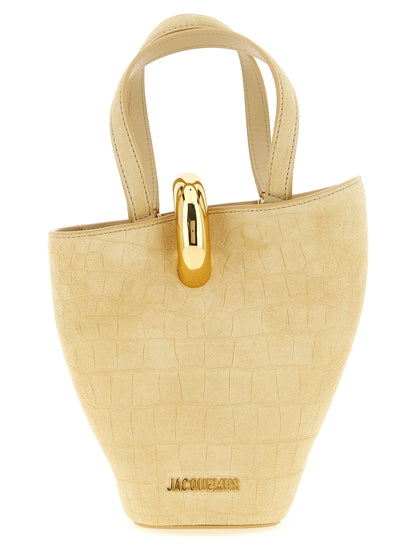 Mini Bucket Handbag by Jacquemus for women in crocodile calfskin suede leather beige features a signature silhouette, showcasing a secure magnetic and signature with versatile shoulder-strap & handle for a sophisticated look.