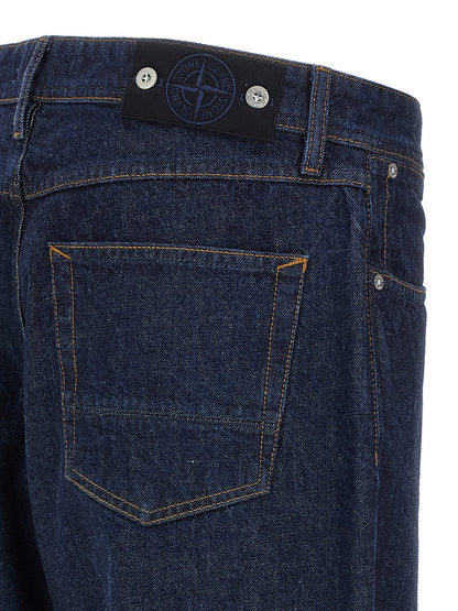 Jeans by Stone Island for men in denim cotton blue & indigo presents a tailored silhouette, showcasing a tailored straight-leg, relaxed-fit & wide and long cut with a refined for a truly tailored aesthetic.