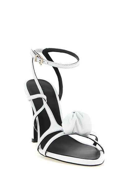 Stiletto Ankle Strap Sandals by ROTATE BIRGER CHRISTENSEN for women in calfskin leather white presents a sculptural silhouette, showcasing the Women's Calfskin Leather Stiletto Ankle Strap Sandals design with a sculptural stiletto and for a premium look.