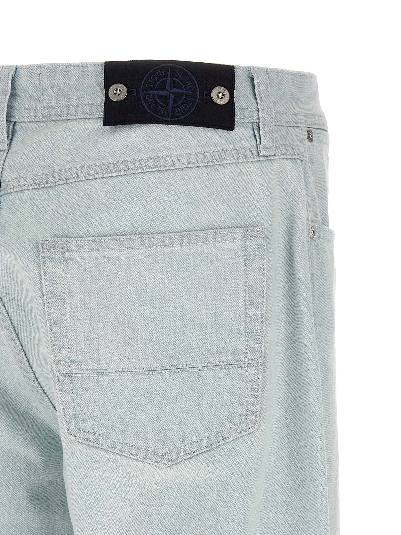 Jeans by Stone Island for men in organic cotton denim indigo & light-blue presents a tailored silhouette, showcasing a tailored straight-leg & wide and long cut with a refined for a truly tailored aesthetic.