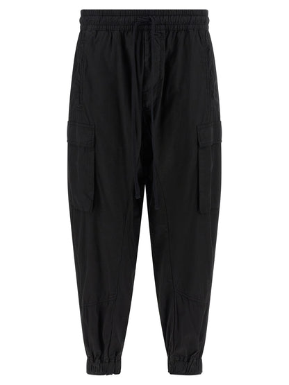 Cargo Pants by Thom Krom for men in organic cotton black features an urban chic relaxed-fit with a and long, creating a urban chic aesthetic for "Moon Behind the Hill".
