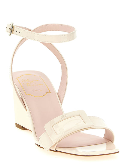 Wedge Ankle Strap Sandals by Roger Vivier for women in patent calfskin leather and white & signature presents a captivating silhouette, showcasing the signature style of the Belle Vivier Women's Patent Calfskin Leather Wedge Ankle Strap Sandals with a captivating wedge and captivating square toe style.
