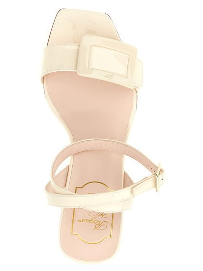 Wedge Ankle Strap Sandals by Roger Vivier for women in patent calfskin leather white & signature features an statuesque Belle Vivier Women's Patent Calfskin Leather Wedge Ankle Strap Sandals silhouette with a refined wedge and elegant square toe style.