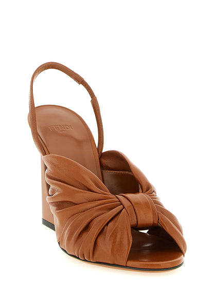 Stiletto Slingback Sandals by Fendi for women in nappa lamb leather and brown & gold presents a captivating silhouette, showcasing the signature style of the Women's Nappa Lamb Leather Stiletto Slingback Sandals with a captivating stiletto and captivating almond toe style.