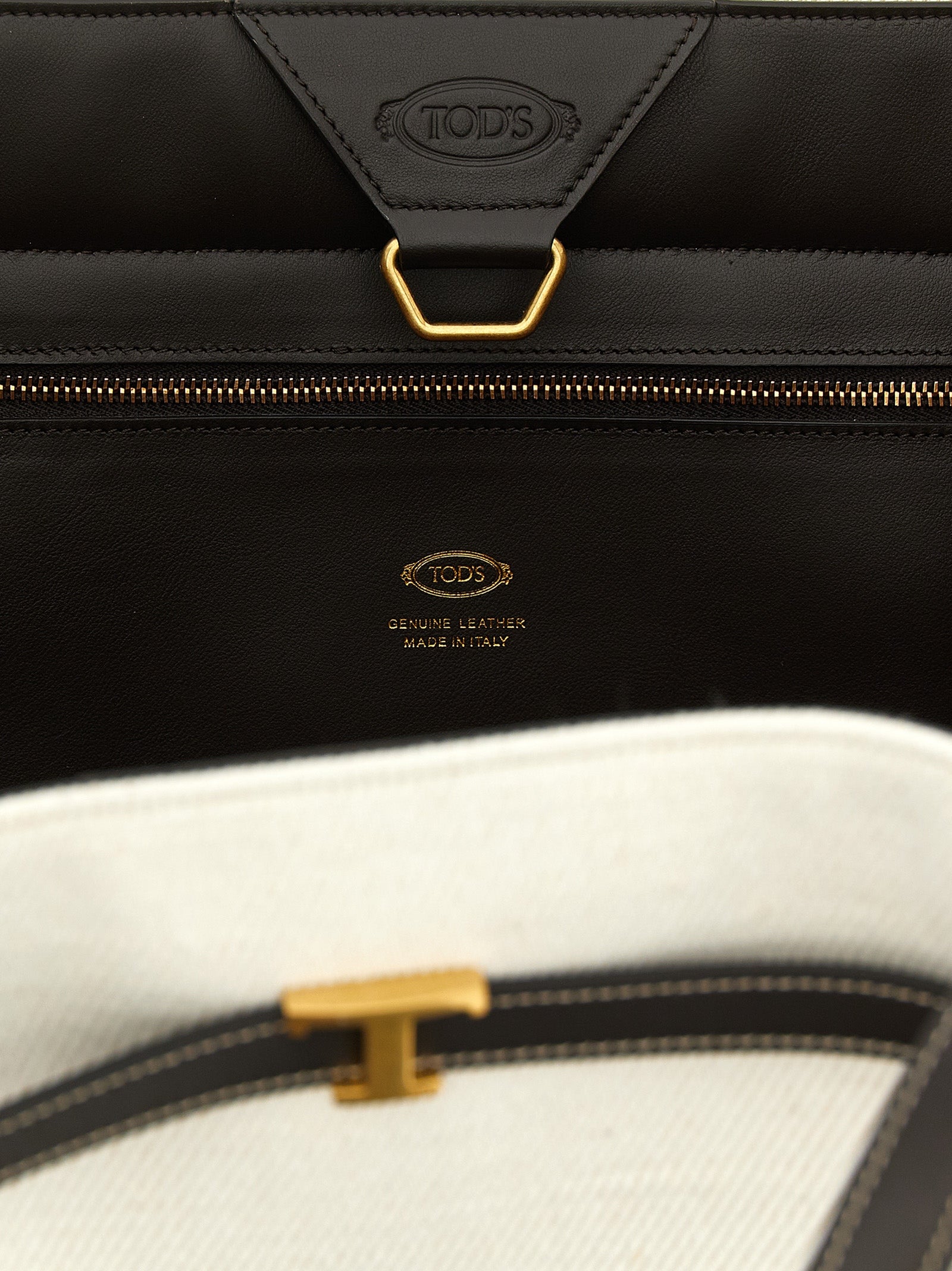 This Medium Shopper Tote Bag by Tod's for women in linen canvas & calfskin leather multicolor features an on trend T Timeless Tim Linen Canvas & Calfskin Leather Medium Shopper Tote Bag design with a secure hook, ample , and on trend adjustable-strap & handle.