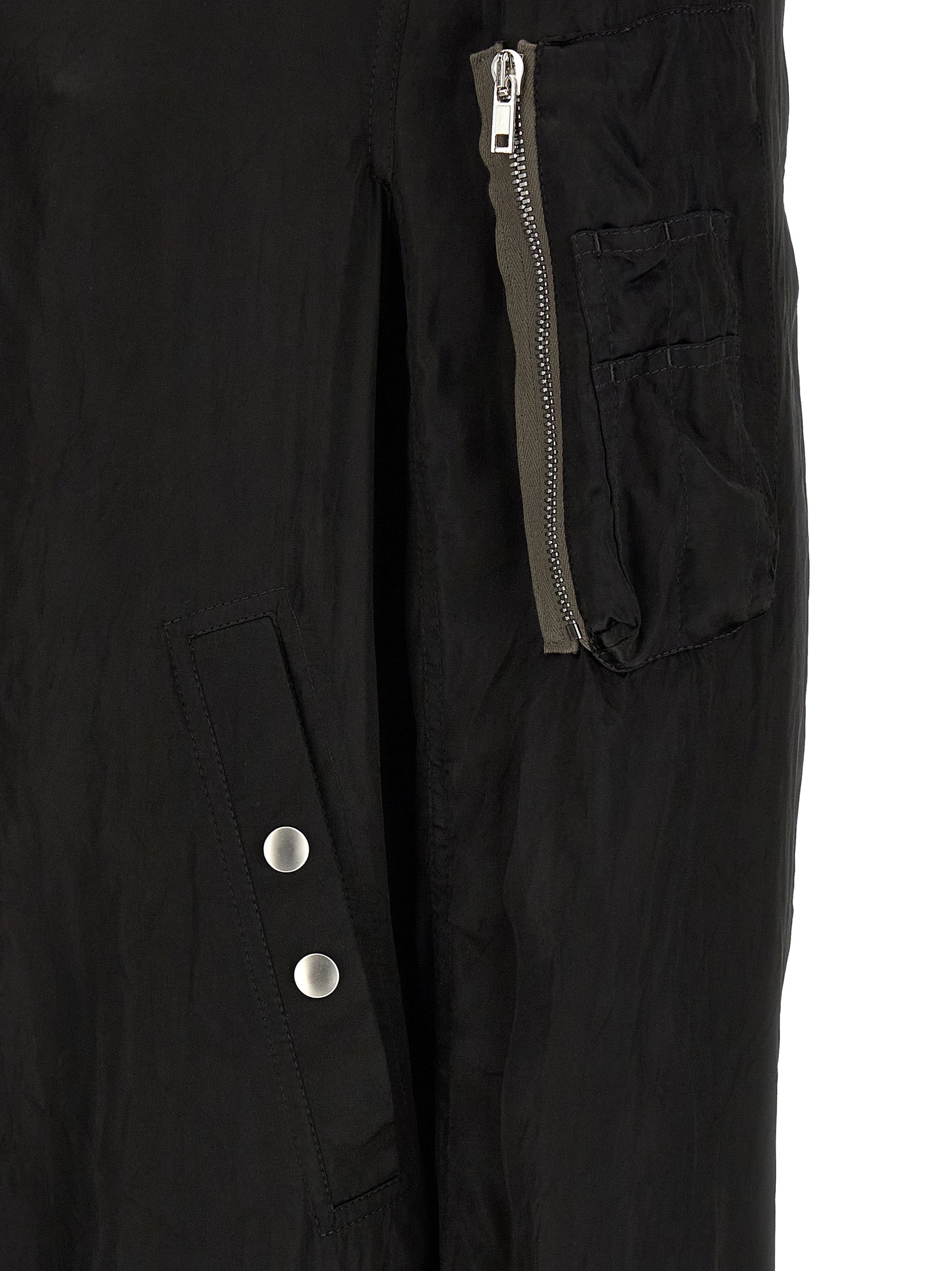 Bomber Jacket by Rick Owens for men in nylon & cupro black & copper showcases a bohemian silhouette, artfully detailed with a bohemian and signature pockets & insulated for a truly bohemian finish.