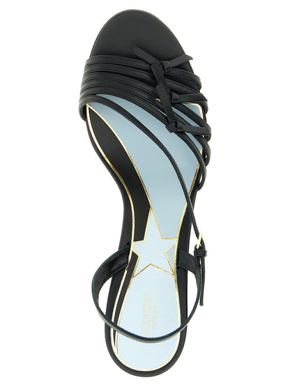 Stiletto Sandals by Valentino Garavani for women in calfskin & brass black, patterned & signature features an exquisite silhouette, showcasing the exquisite Star V Logo Women's Calfskin & Brass Stiletto Sandals with a stiletto and .