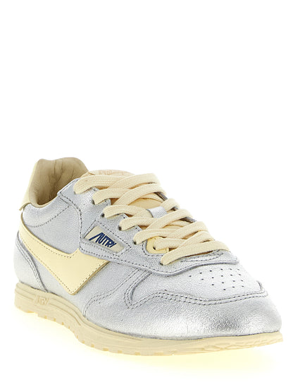 Sneakers by Autry for women in nylon cotton terry & cowhide leather natural, silver & jacquard features an timeless silhouette from the Women's Low Top Nylon Cotton Terry & Cowhide Leather Sneakers collection, showcasing a signature low-top style with an timeless finish.