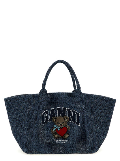 Shopper Tote Bag by Ganni for women in tweed organic cotton denim blue features an utilitarian-chic silhouette, showcasing the Bear Tweed Organic Cotton Denim Shopper Tote Bag design with a secure , ample , and versatile handle.