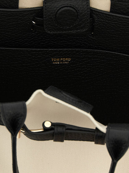 Shopper Tote Bag by Tom Ford for women in cotton polyester canvas bicolour, black & white features a jet-set Audrey Cotton Polyester Canvas Shopper Tote Bag design, complete with a secure magnetic & buckle, ample , and versatile shoulder-strap, adjustable-strap & handle for a jet-set look.