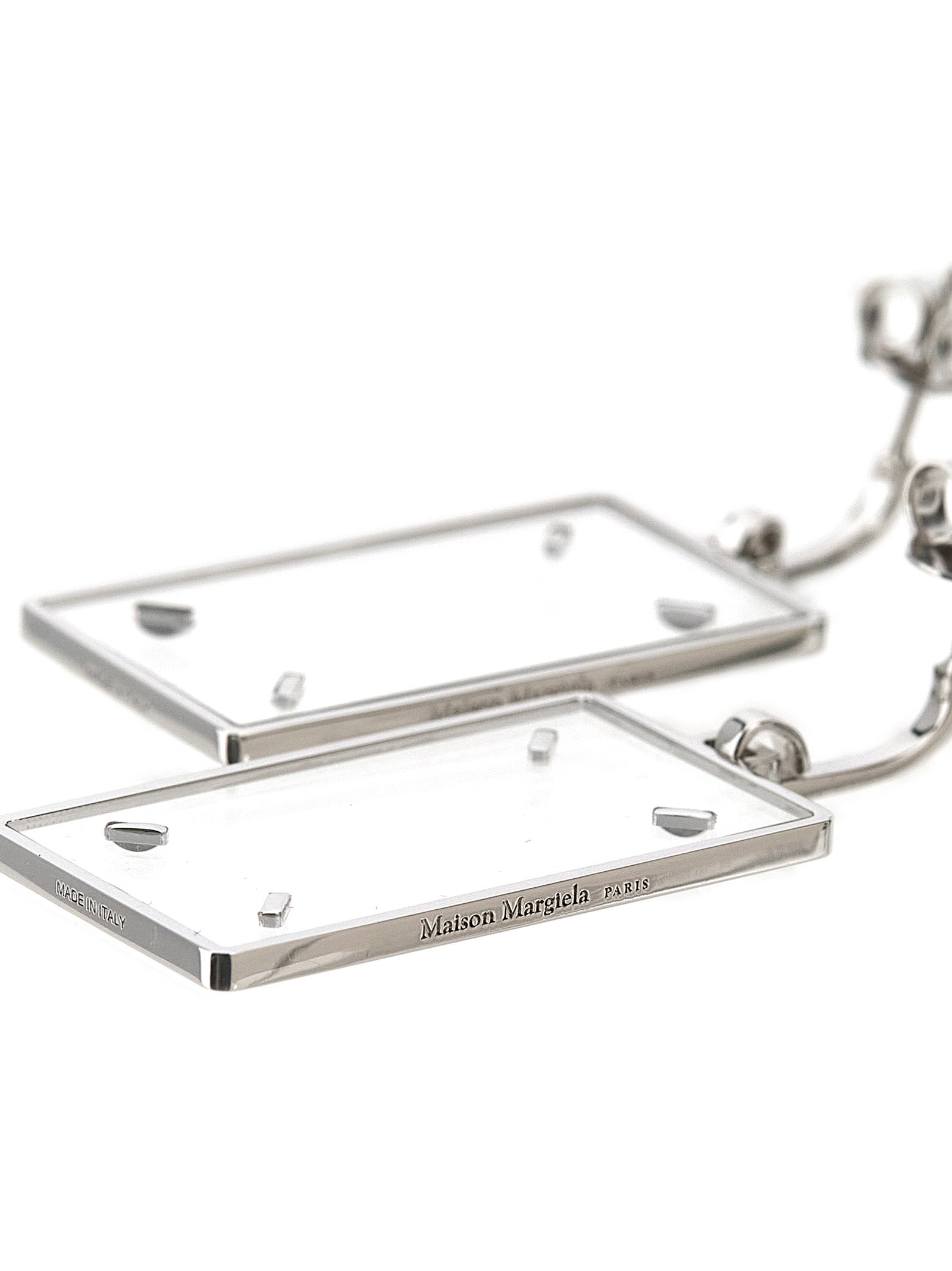 Earrings by Maison Margiela for women in calfskin leather silver showcases a artisanal silhouette, artfully capturing the essence of Four Stitches Women's Silver Brass Earrings with its exquisite .