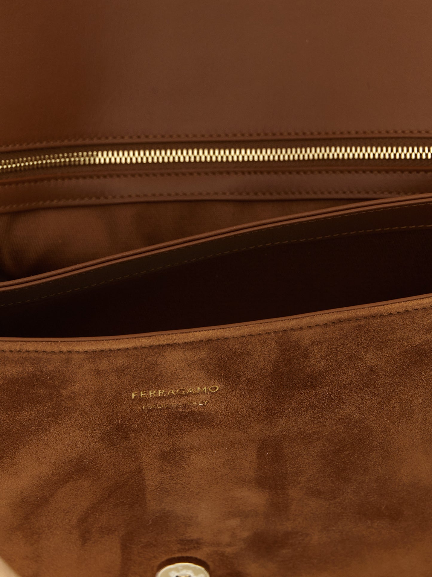 Shoulder Evening Saddle Bag by Ferragamo for women in suede leather brown & signature features a enviable silhouette, showcasing a secure flap & magnetic, ample , and enviable shoulder-strap, handle & adjustable-strap for a enviable finish.