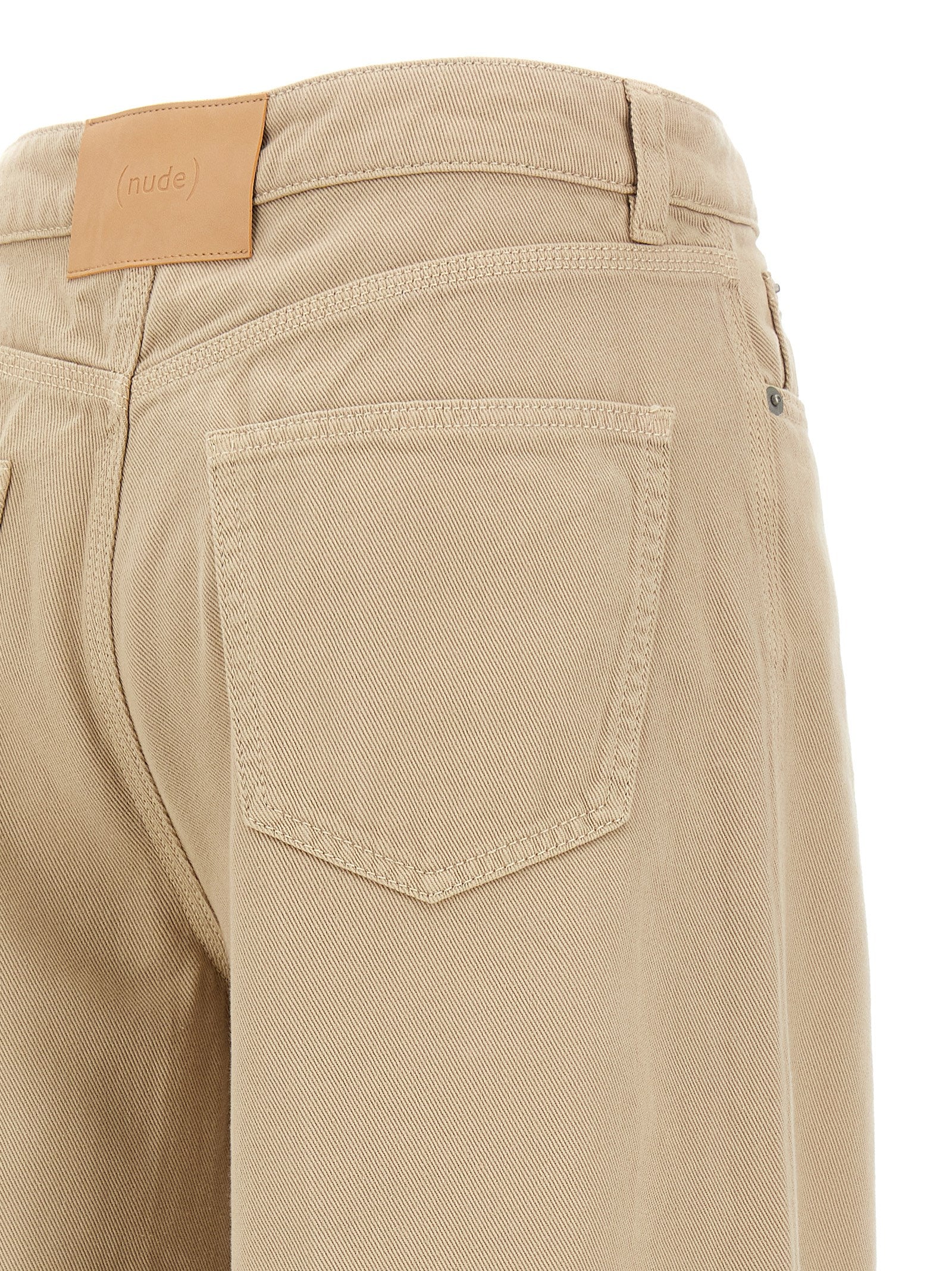 Trousers by NUDE for women in cotton beige, nude & signature features a artisanal silhouette, showcasing a sophisticated flared with a long and for a artisanal finish.