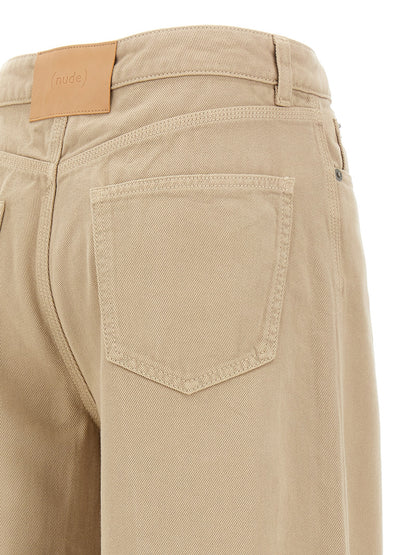 Trousers by NUDE for women in cotton beige, nude & signature features a artisanal silhouette, showcasing a sophisticated flared with a long and for a artisanal finish.