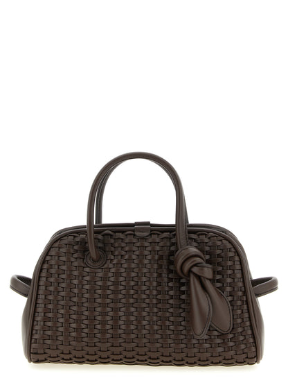 This Bowling Handbag by Jacquemus for women in polyester cotton & suede leather and brown, patterned & chevron presents a sculptural silhouette featuring a secure zipper, ample , and versatile adjustable-strap & handle for a sculptural finish.