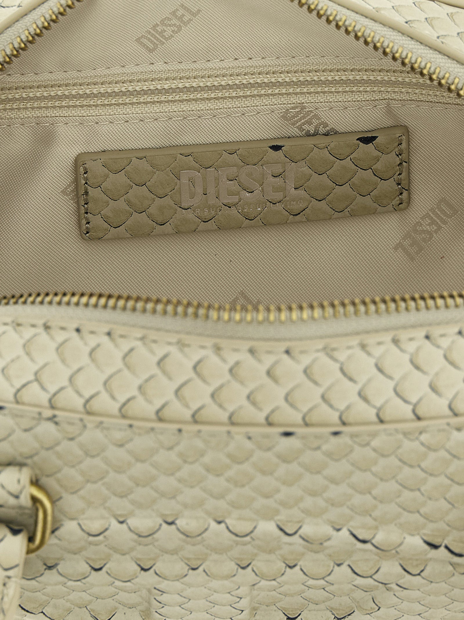 Shoulder Dome Bag by Diesel for women in leather & metal beige features an effortlessly chic silhouette with a secure zipper, ample , and versatile shoulder-strap & handle for effortlessly chic everyday luxury.