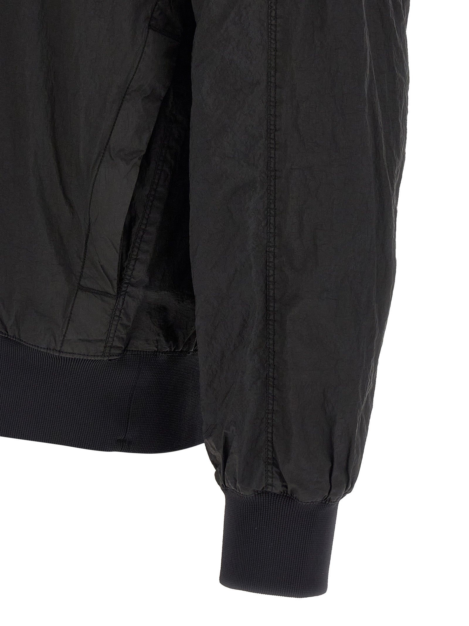 Hooded Bomber Jacket by Stone Island for men in nylon black features a dramatic silhouette, showcasing a sophisticated and distinctive pockets & hooded for a dramatic aesthetic.
