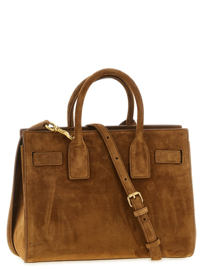 Small East West Handbag by Saint Laurent for women in suede calfskin leather brown & signature presents a ornamental silhouette, showcasing a secure , ample , and versatile adjustable-strap & handle for a ornamental finish.