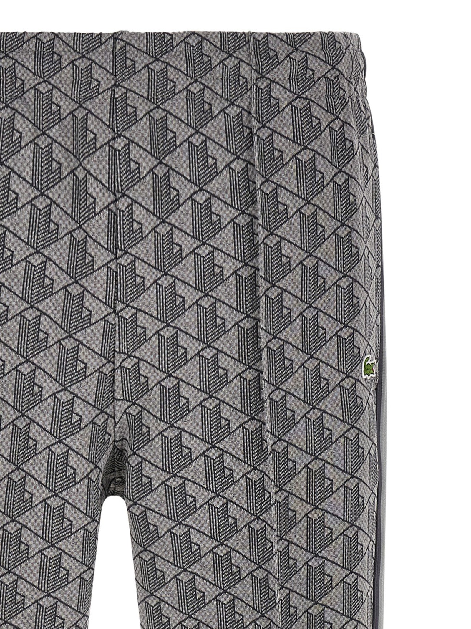 Joggers by Lacoste for men in polyamide polyester & cotton gray, jacquard & monogram features a refined silhouette with a refined straight-leg, defined by a and a refined long for a refined finish.