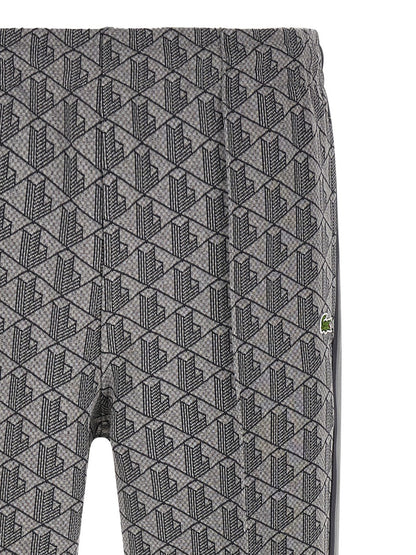 Joggers by Lacoste for men in polyamide polyester & cotton gray, jacquard & monogram features a refined silhouette with a refined straight-leg, defined by a and a refined long for a refined finish.