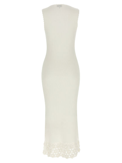 Dress by Ganni for women in organic cotton & polyamide white features an cute silhouette, detailed with a and v-neck neckline that elegantly flows into a cute long.