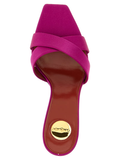 Stiletto Mules Sandals by Saint Laurent for women in viscose silk satin & leather fuchsia presents a sculptural silhouette, showcasing the Cassandre Women's Viscose Silk Satin & Leather Stiletto Mules Sandals design with a sculptural stiletto and for a premium look.