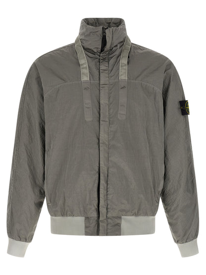 This Hooded Bomber Jacket by Stone Island for men in nylon gray exhibits a edgy silhouette, meticulously detailed with functional hooded and a edgy hooded neckline for a edgy finish.