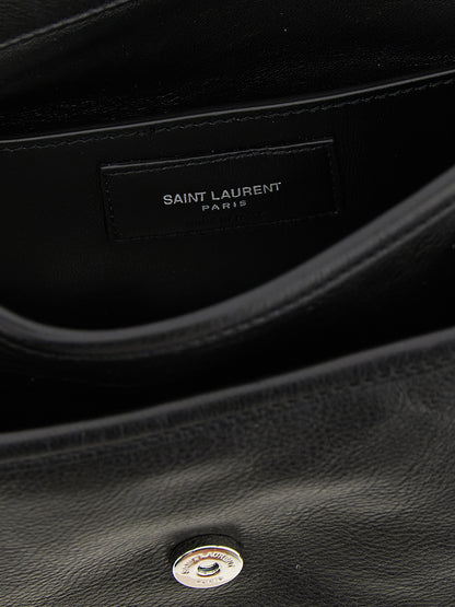 Small Crossbody Messenger Bag by Saint Laurent for men in calfskin leather black showcases a stylish Cassandre Essence Niki Calfskin Leather Small Crossbody Messenger Bag design, featuring a secure flap & magnetic and ample with versatile crossbody-strap, shoulder-strap & adjustable-strap for a stylish look.