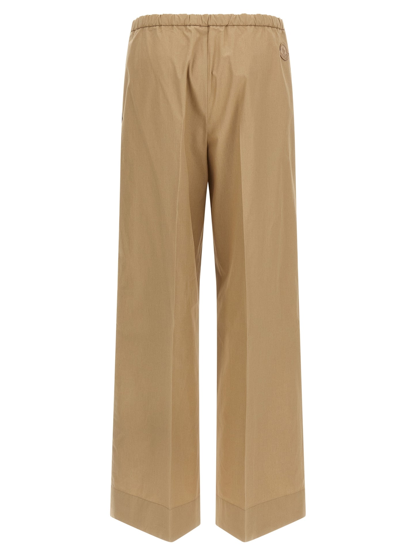 Trousers by Moncler for women in cotton beige presents a perennial silhouette, meticulously tailored with a straight & wide cut, long finish, and an elegant .
