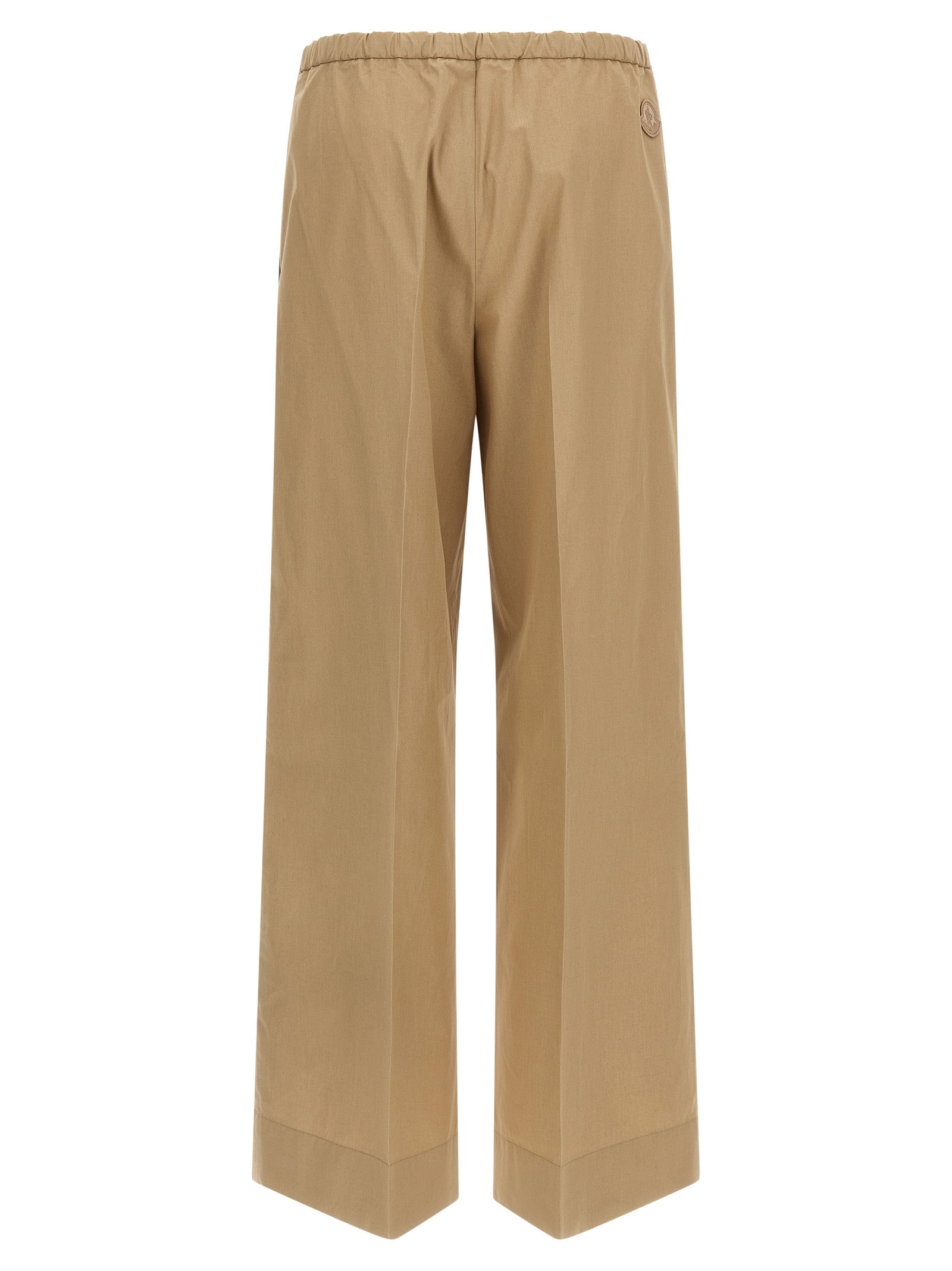Trousers by Moncler for women in cotton beige presents a perennial silhouette, meticulously tailored with a straight & wide cut, long finish, and an elegant .