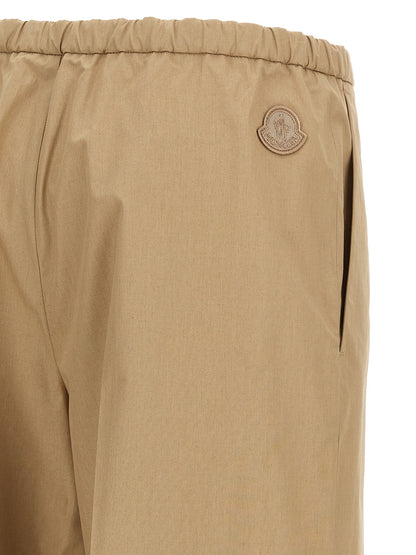Trousers by Moncler for women in cotton beige features a sculptural silhouette, showcasing a sculptural straight & wide and long with a sophisticated for a sculptural finish.