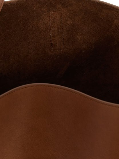 Large Shoulder Clutch Bag by Saint Laurent for women in suede calfskin leather brown presents a versatile silhouette, showcasing a secure and versatile with versatile shoulder-strap, adjustable-strap & handle for a sophisticated look.