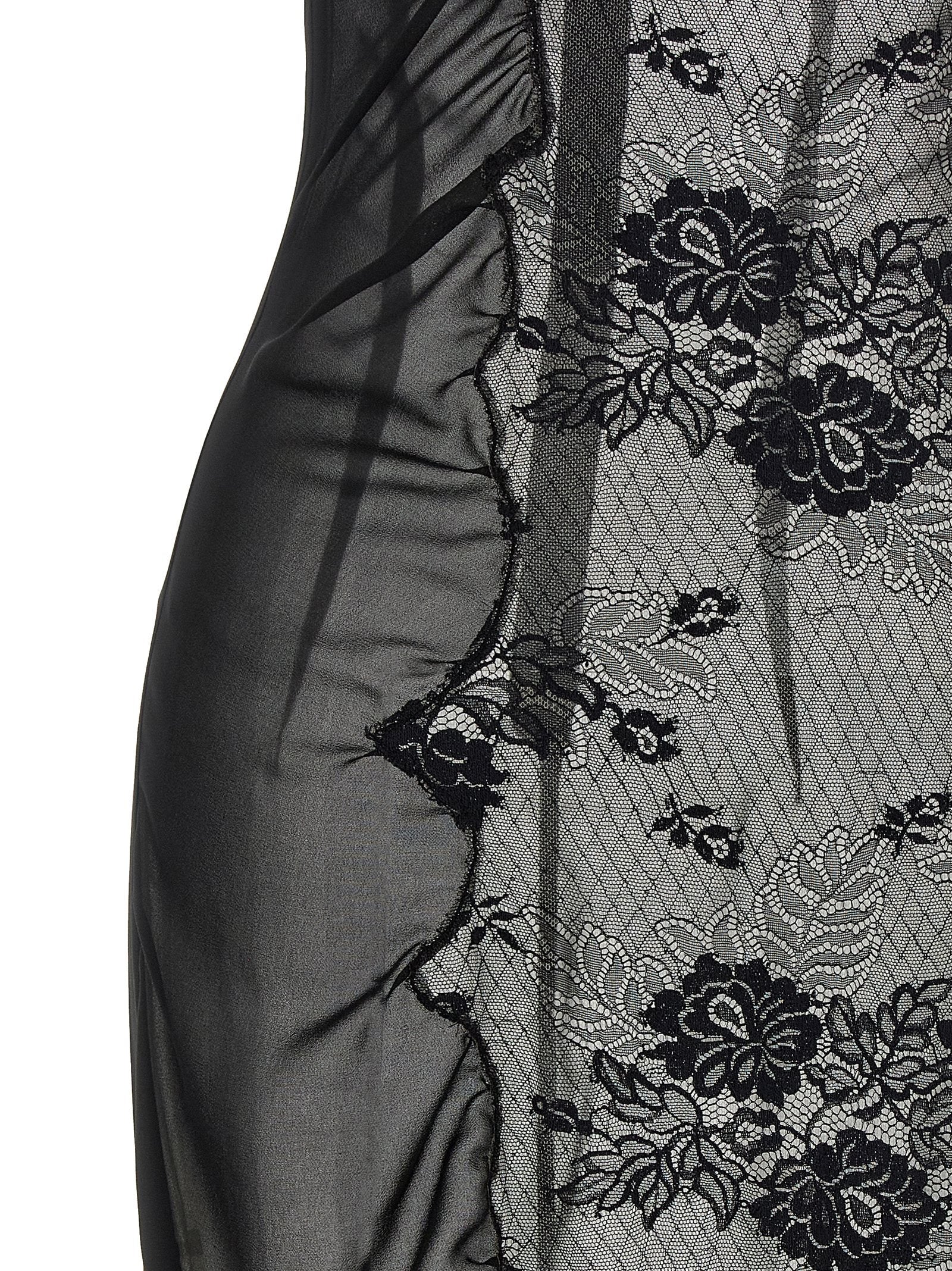 Dress by The Attico for women in polyamide cotton black presents a sinuous silhouette, showcasing a sophisticated high-neck neckline and detailed with a sinuous midi short for a refined finish.