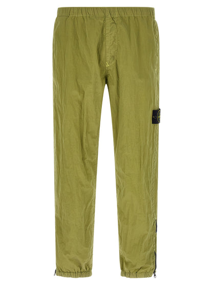 Joggers by Stone Island for men in nylon bicolour & green features an sartorial tapered-leg and long with a cut for a sartorial finish.