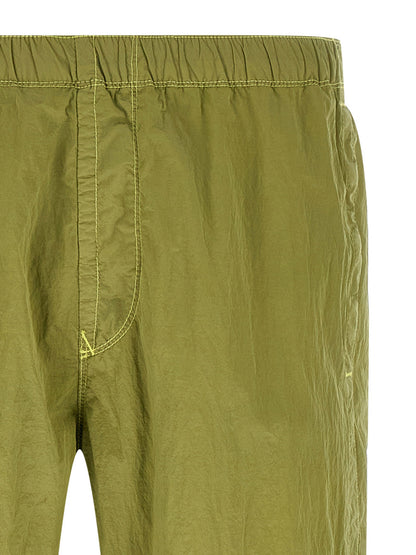 Joggers by Stone Island for men in nylon bicolour & green features a refined silhouette with a refined tapered-leg, defined by a and a refined long for a refined finish.