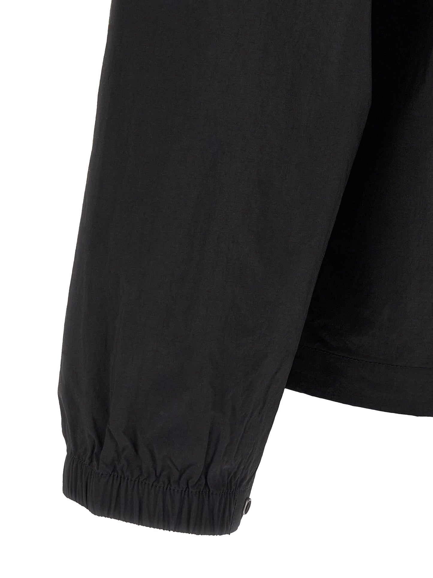 Windbreaker Jacket by The North Face for men in nylon black & red showcases a urban chic silhouette, detailed with a urban chic and functional pockets & windproof for a polished finish.