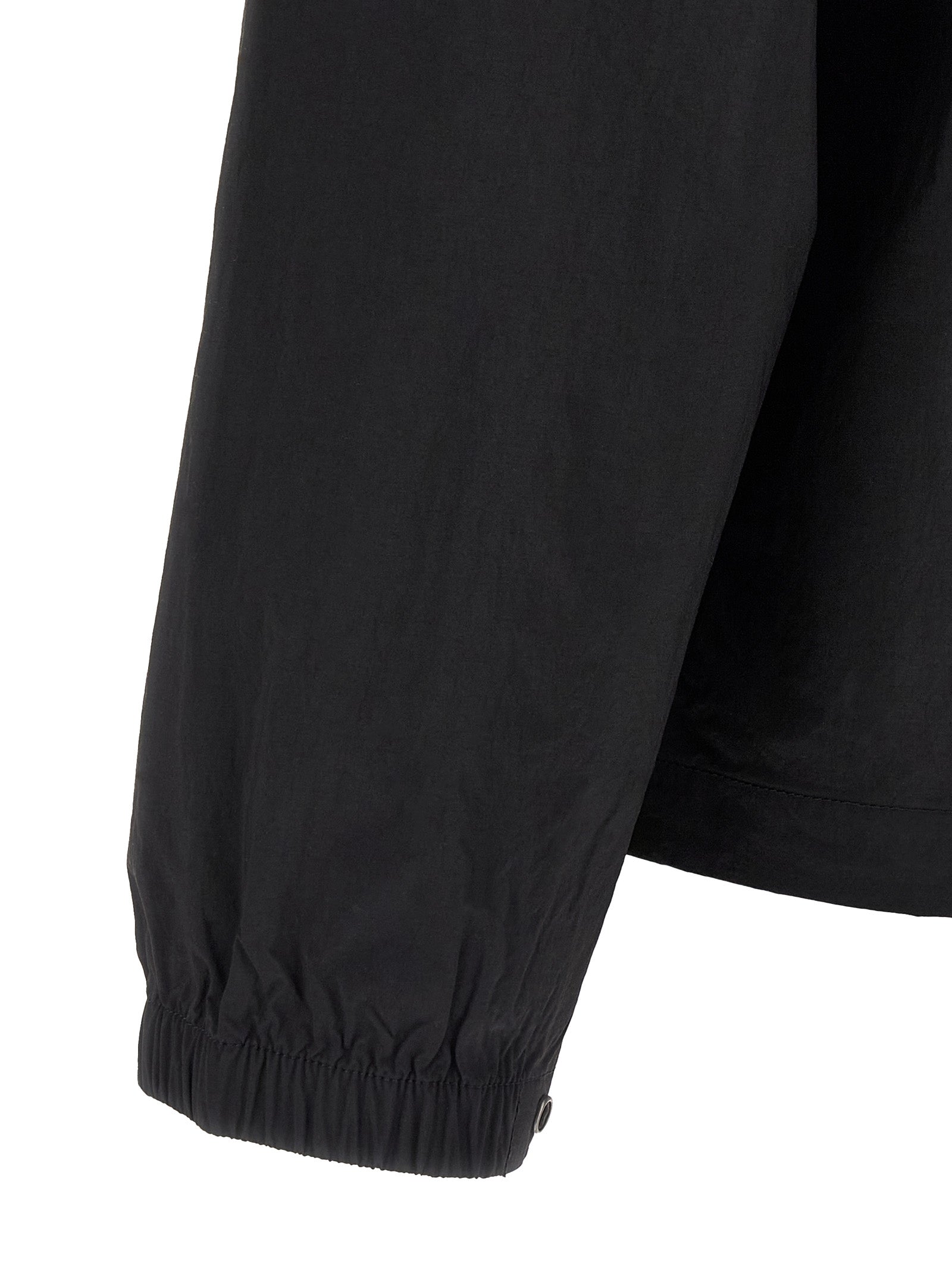 Windbreaker Jacket by The North Face for men in nylon black & red showcases a urban chic silhouette, detailed with a urban chic and functional pockets & windproof for a polished finish.
