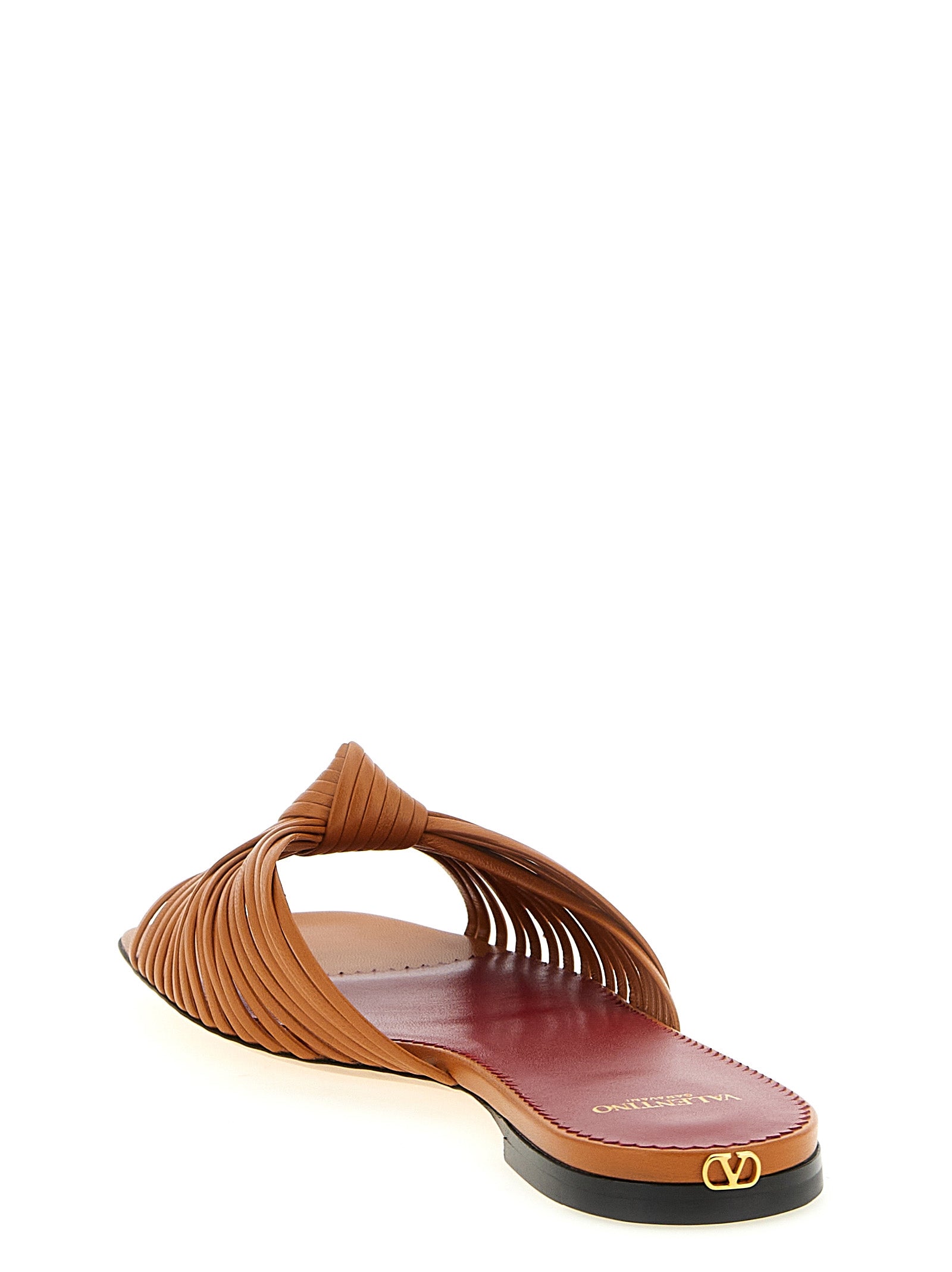 Sliders Sandals Flat Shoes by Valentino Garavani for women in goatskin leather & brass brown & signature presents a impeccable silhouette as V Logo Women's Goatskin Leather & Brass Sliders Sandals Flat Shoes, artfully designed with a and a impeccable square toe style for a refined, upscale finish.